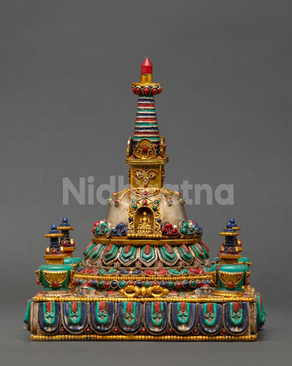 Front view of Tibetan Buddhist Stupa handcrafted by Newari artisans with 24K gold and silver plating, sacred Himalayan altar sculpture with Buddha eyes and jewel finial