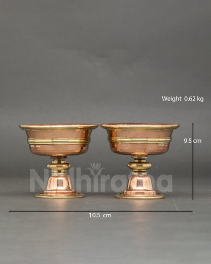 Front view of two butter lamps, handcrafted from copper, Tibetan altar Chome set from Nepal