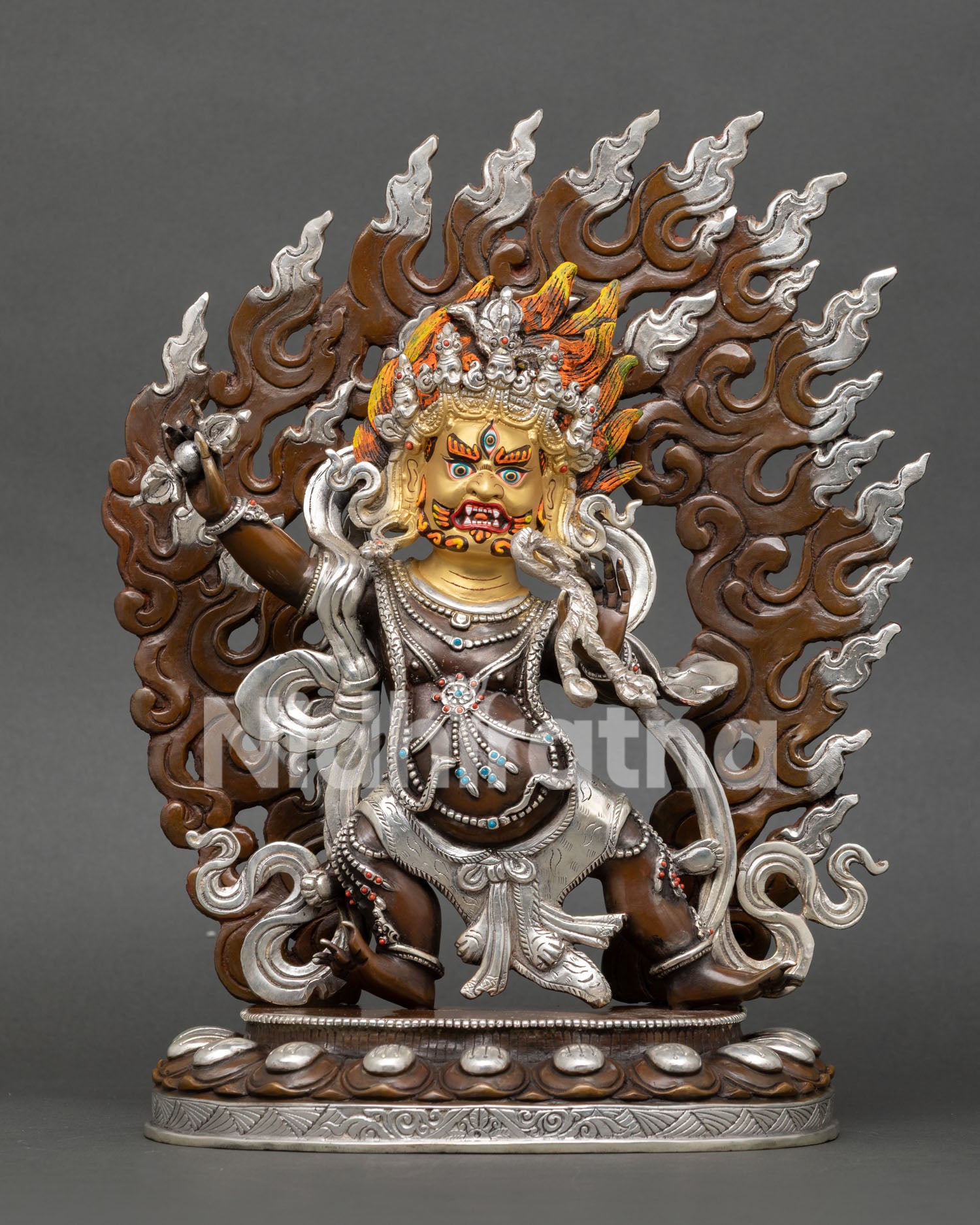 Front view of Vajrapani statue with oxidized and silver plated copper finish with gold painted wrathful face