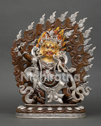 Front view of Vajrapani statue with oxidized and silver plated copper finish with gold painted wrathful face