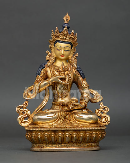 Front view of Vajrasattva statue, copper with gold painted face, seated on lotus pedestal, handmade Newari craftsmanship