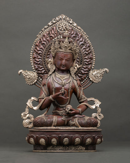 Front view of Vajrasattva statue handcrafted in oxidized copper with silver plated finish seated on lotus pedestal with halo behind head.