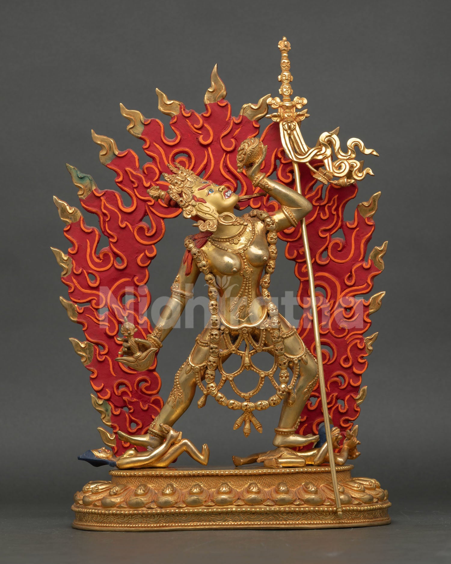 Front view of Vajrayogini statue handcrafted in copper with 24k gold fire gilding dynamic dancing posture flaming halo and Tibetan Buddhist altar spiritual decor.
