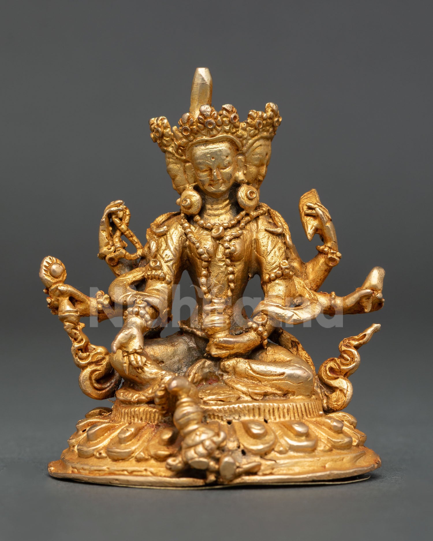 Front view of Vasudhara copper statue gold fire gilded Buddhist goddess of wealth Nepal handmade altar sculpture lotus seat decor