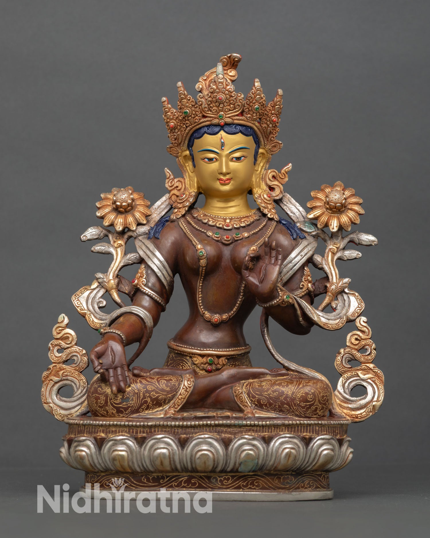 Front view of White Tara statue with copper oxidized finish and gold painted face for altar and meditation