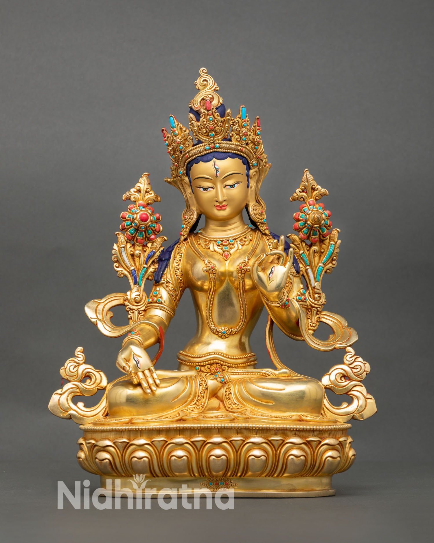 Front view of White Tara statue handcrafted in Nepal with gold gilded copper and serene gold painted face