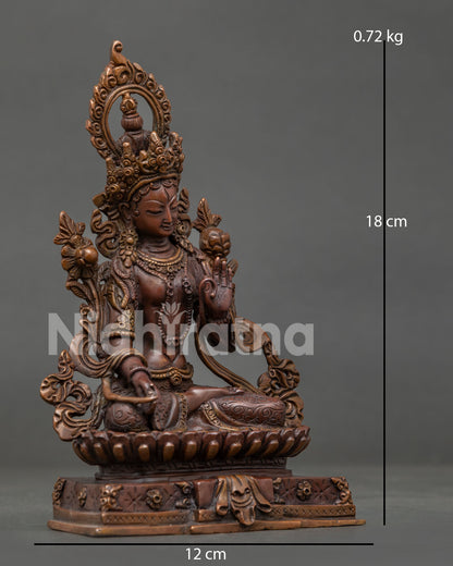 Front view White Tara statue with seven all-seeing eyes and lotus pedestal.