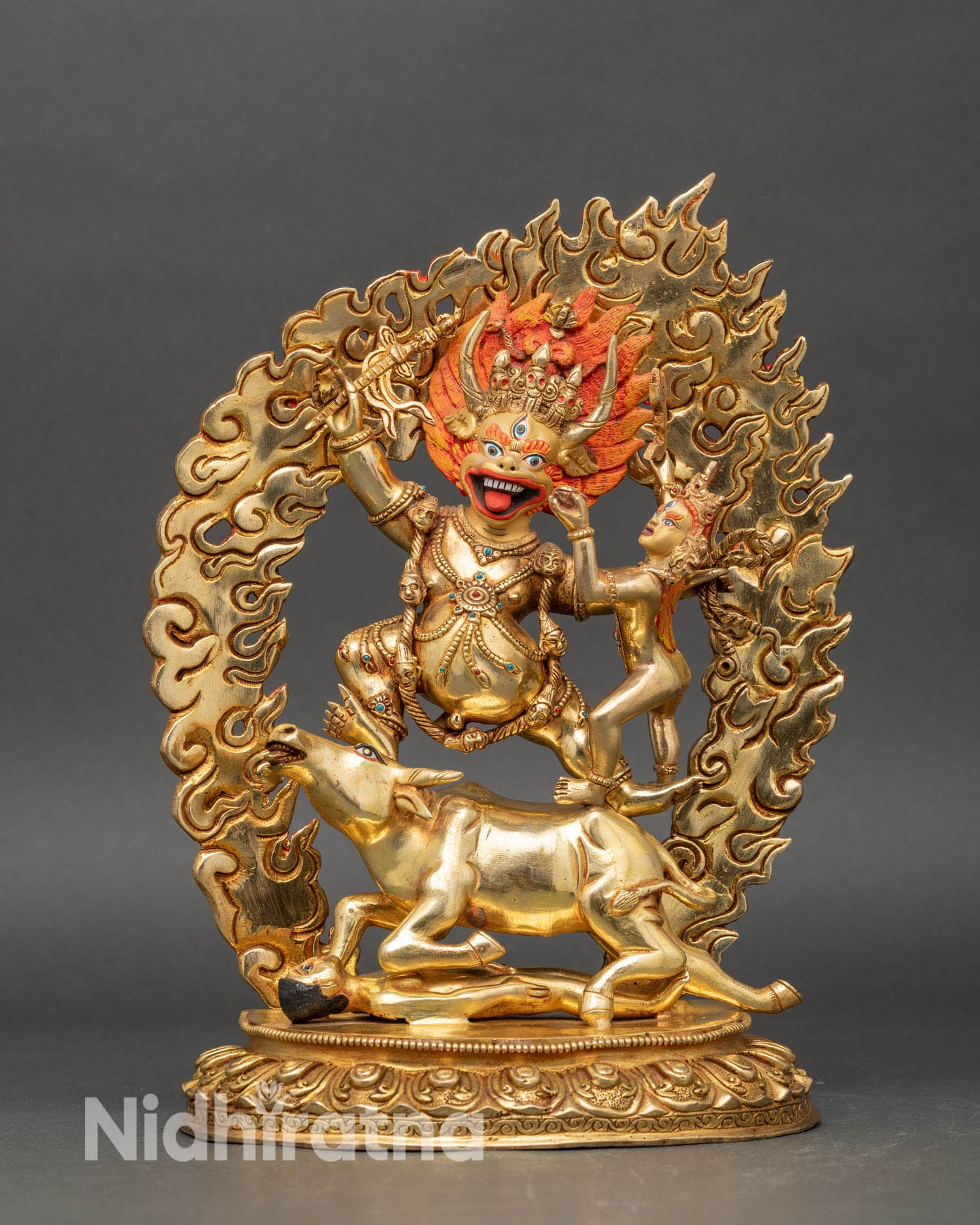 Front view Yamantaka statue handcrafted in copper, fire-gilded in gold, standing on a buffalo