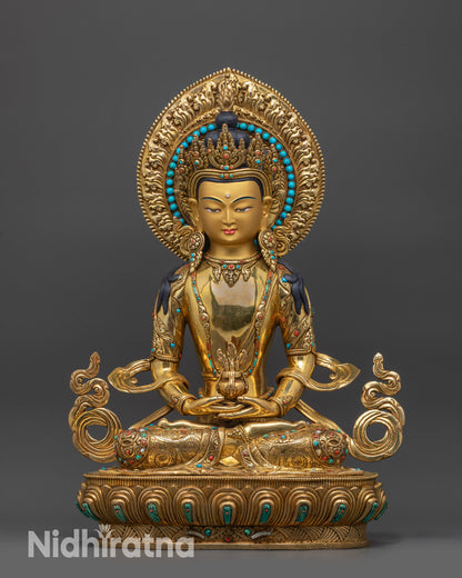 front view Golden Amitayus statue seated on lotus pedestal holding long-life nectar vase