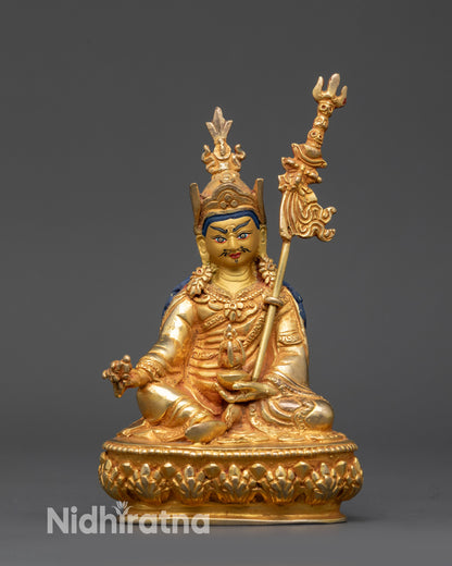 front view Guru Rinpoche Padmasambhava statue with vajra and skull cup details
