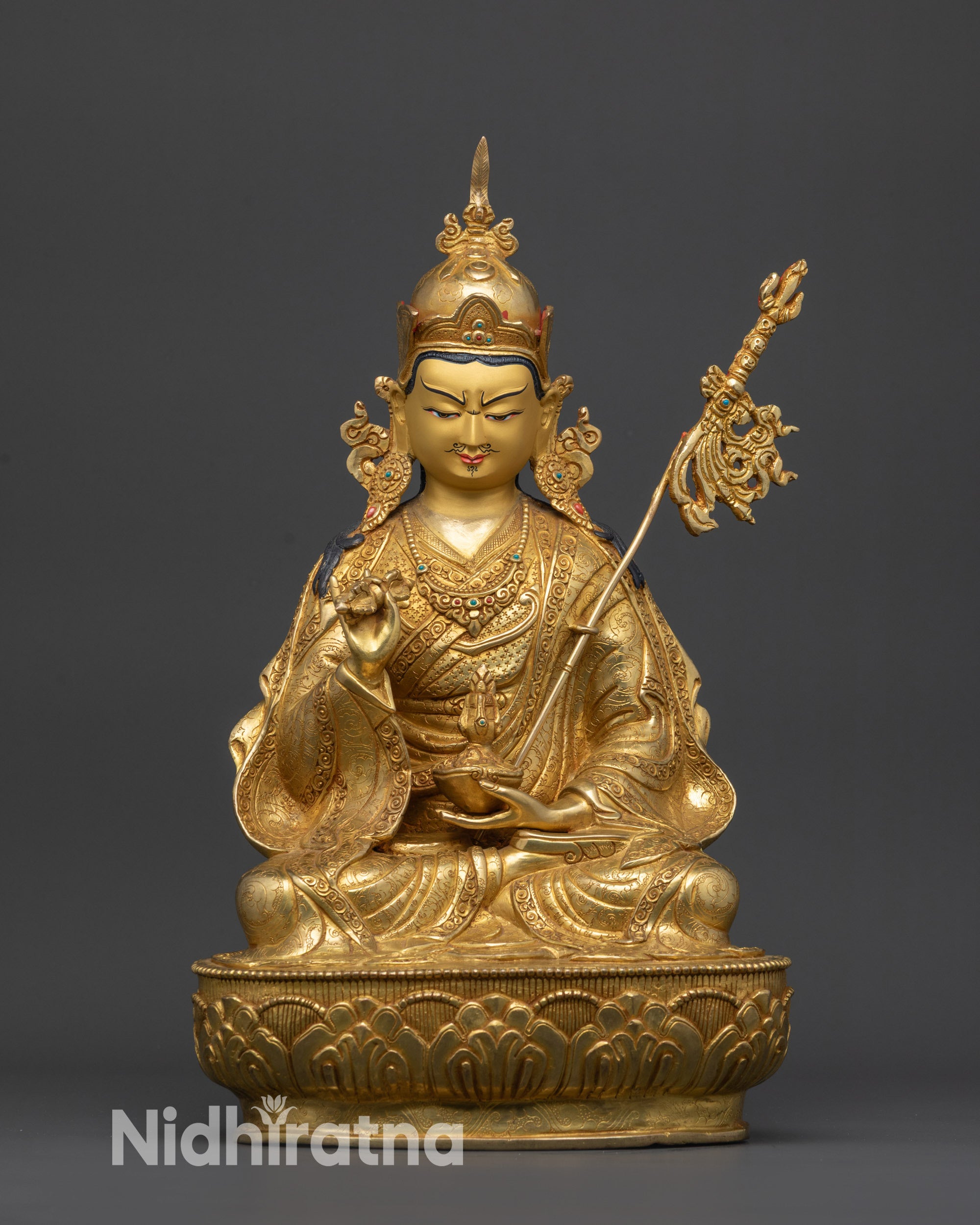 front view Guru Tsokye Dorje statue with gold-gilded face and lotus pedestal detail
