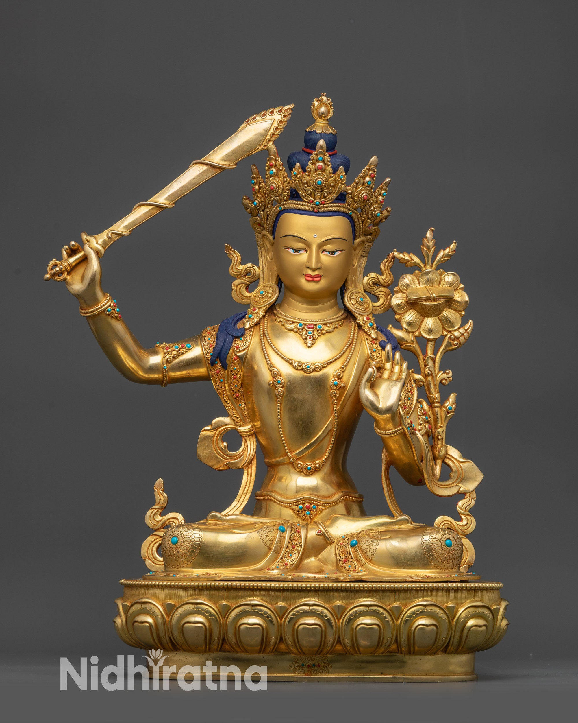 front view Manjushri statue with gold-gilded face and lotus pedstal