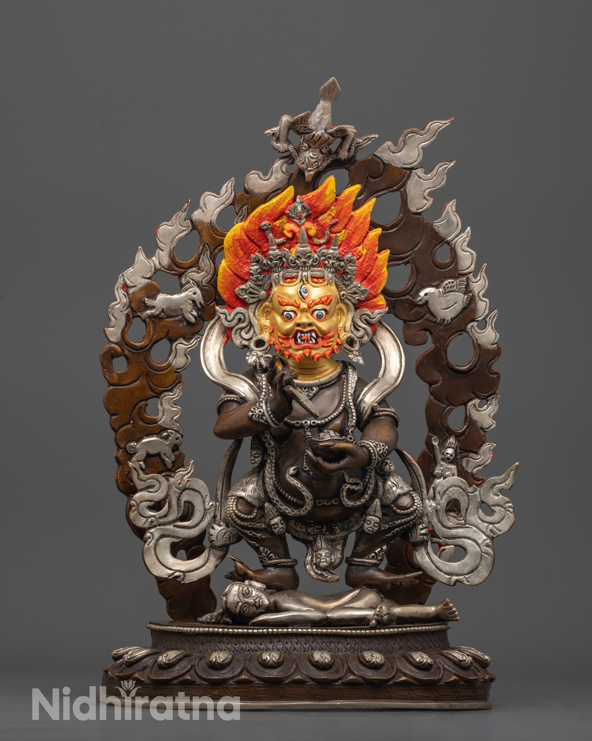 front view Sakya Mahakala statue with gold-gilded face and silver-plated halo from Nepal
