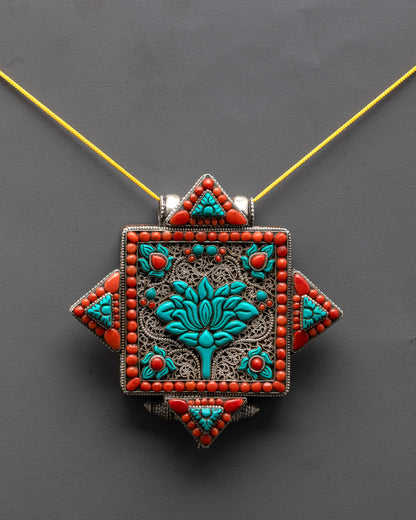 front view Tibetan lotus locket with coral and turquoise stones in silver filigree design

