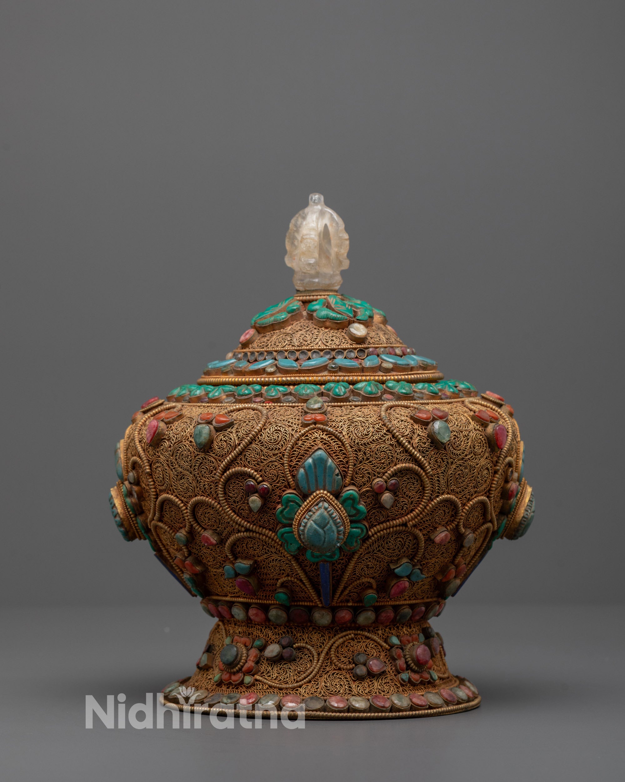 front view Tibetan rice pot in copper with gold filigree, deity figures, and gemstones