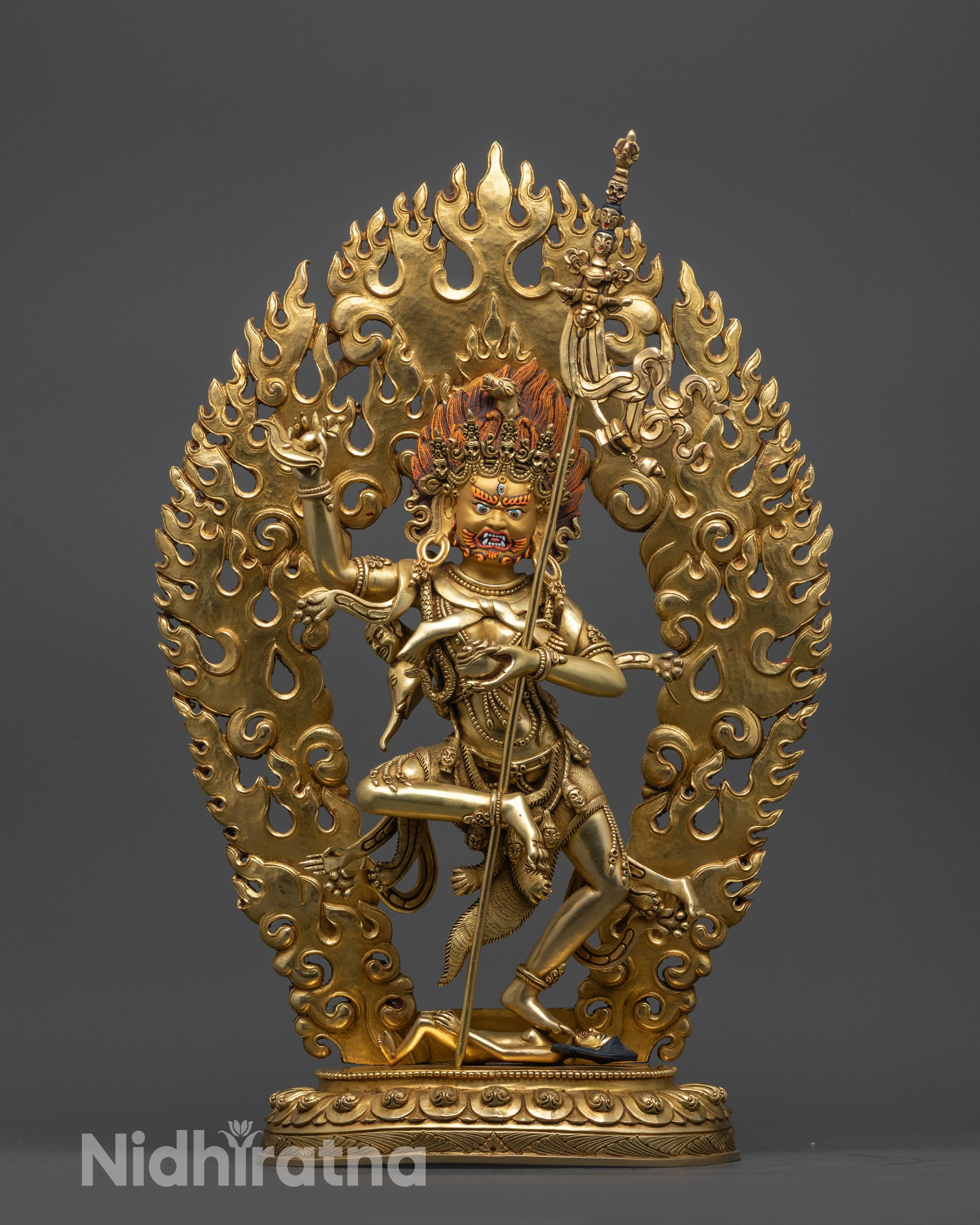 front view Troma Nagmo statue with gold gilded face and five skull crown
