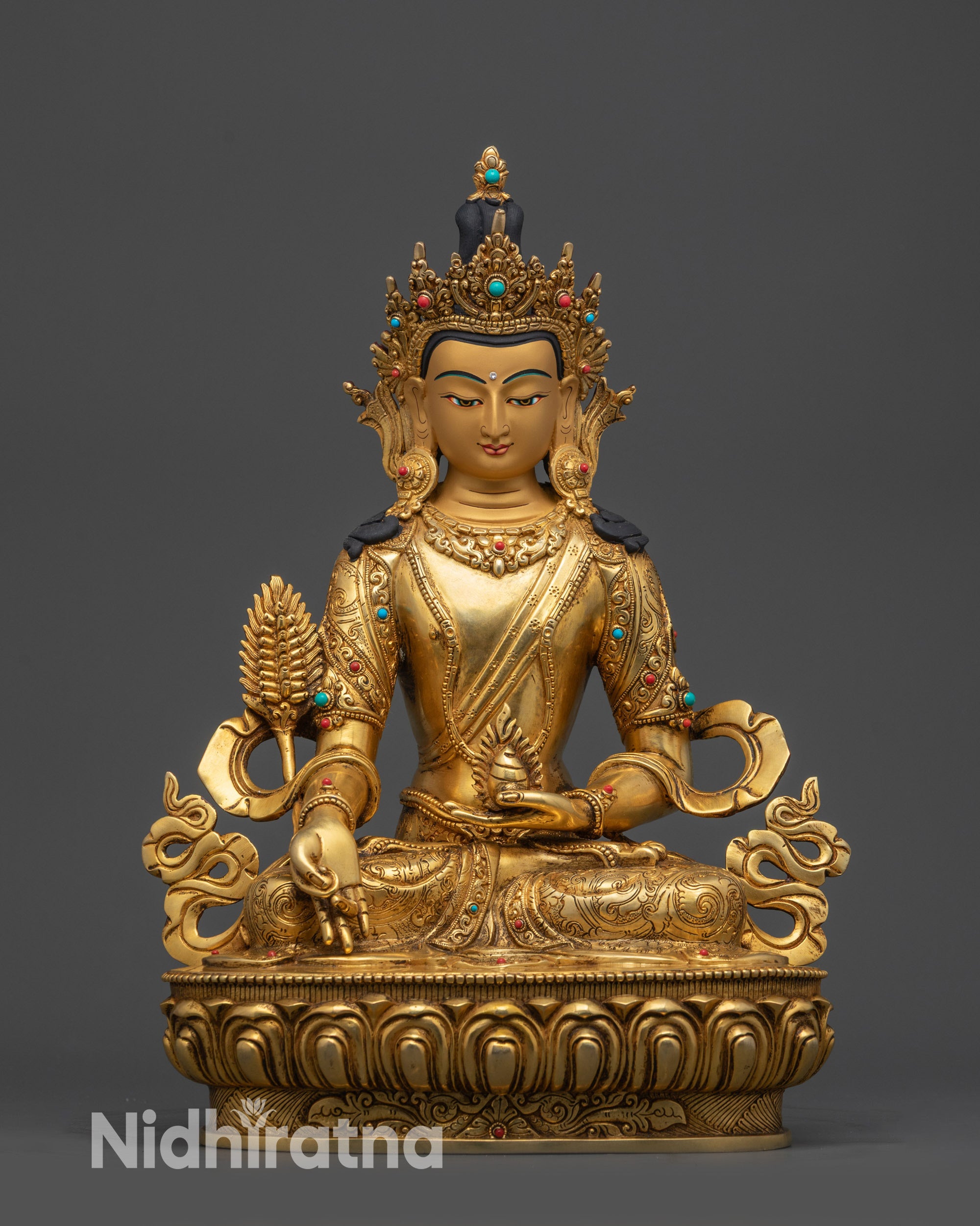 front view kshitigarbha statue on lotus pedestal with gold-gilded face

