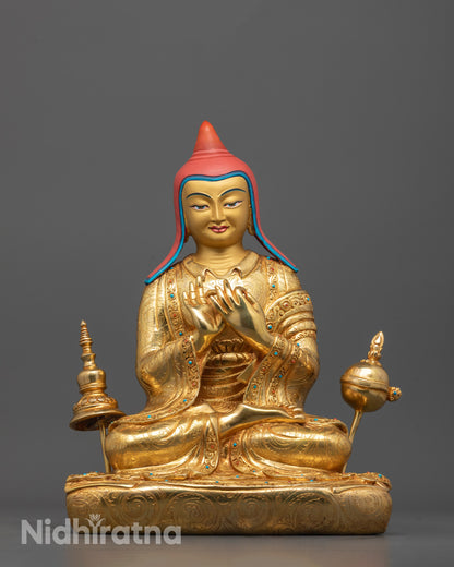 front view of Atisa statue with gold-gilded face and fire-gilded body in dharmachakra mudra