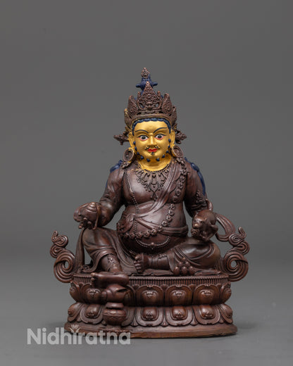 front view of Dzambhala statue with oxidized copper body and 24K gold-plated face