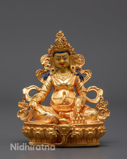 front view of Jambhala statue with gold-gilded face and mongoose in hand