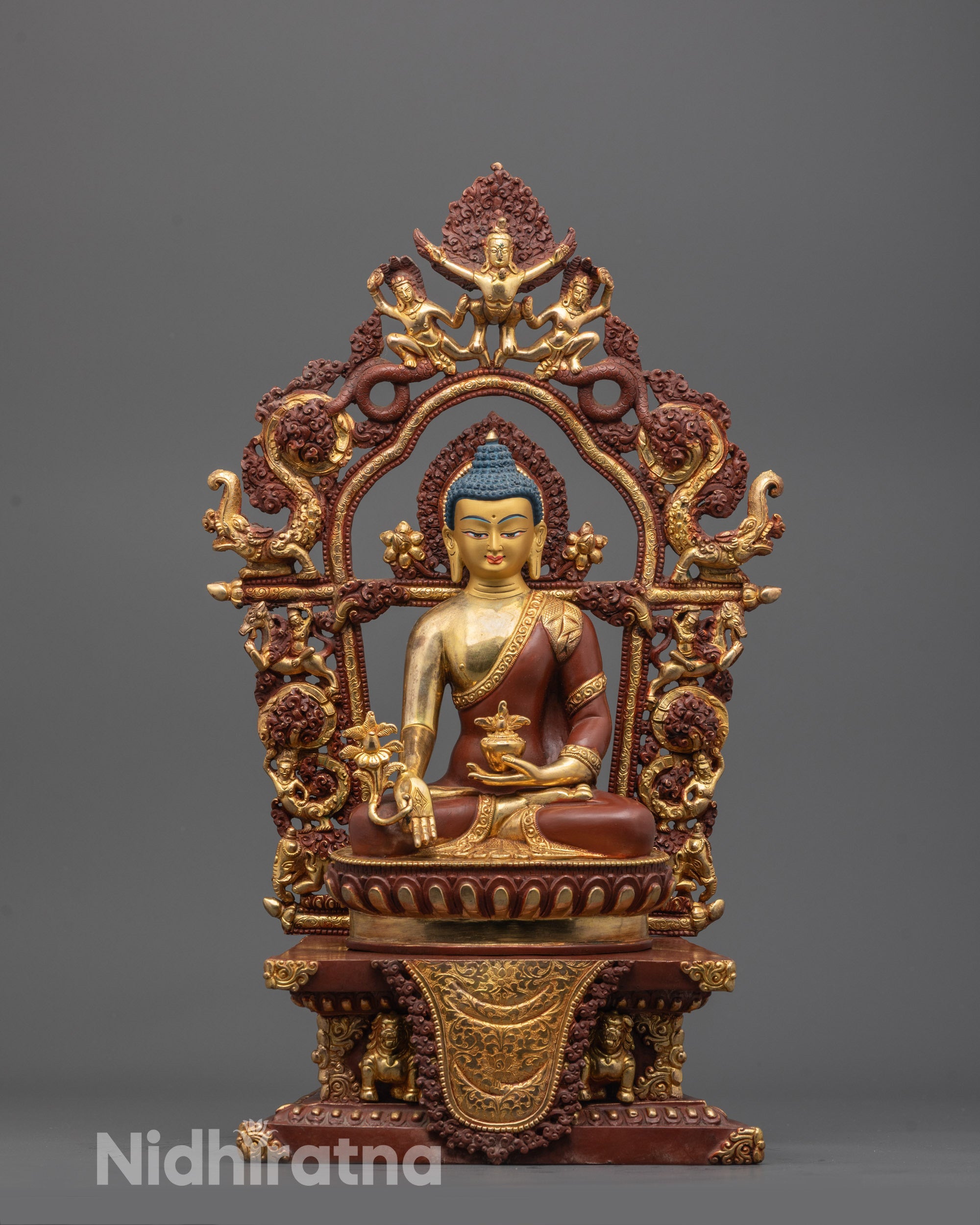 front view of Medicine Buddha on throne statue with gold face and halo for meditation spaces