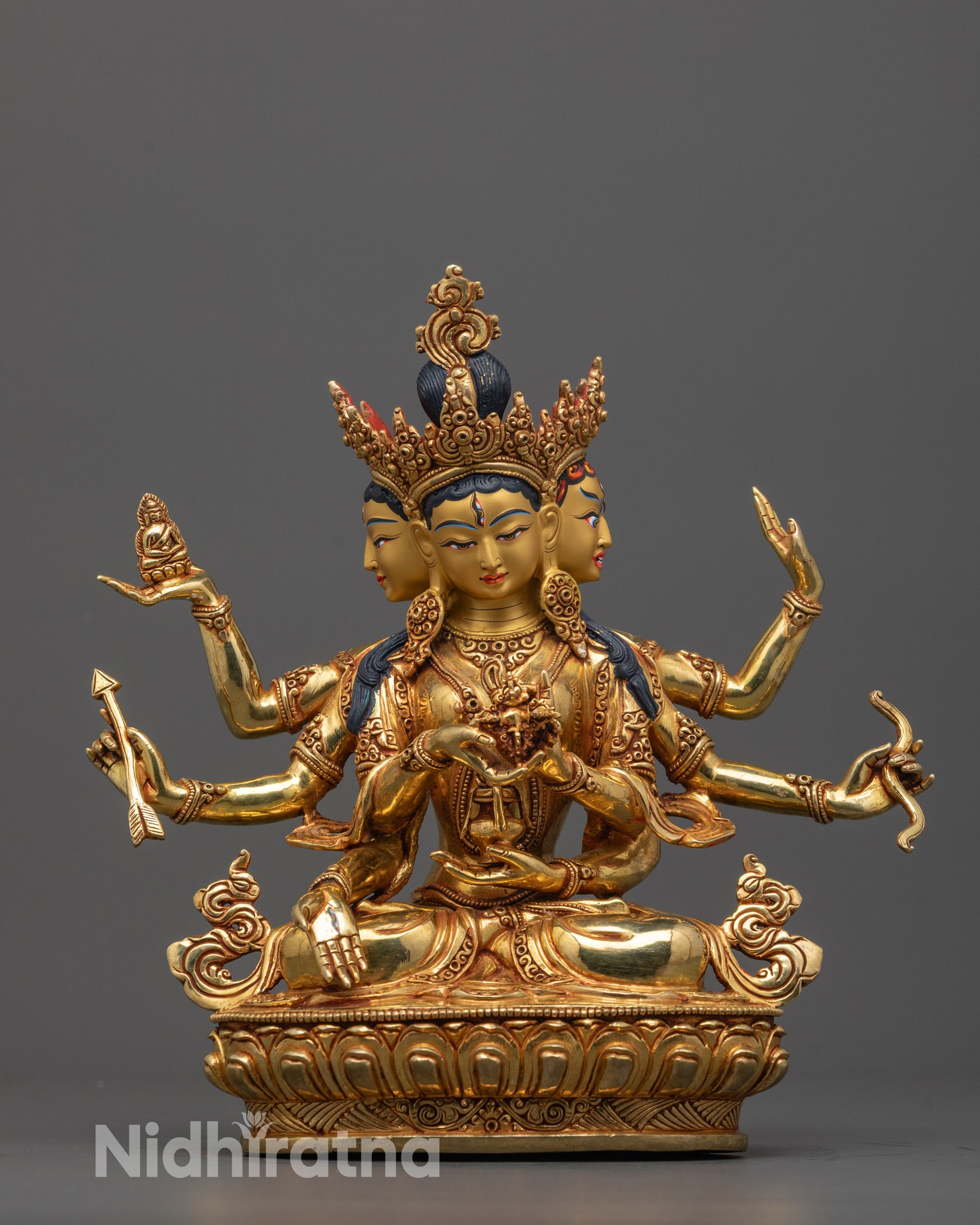 front view of Namgyalma statue with three faces and eight arms on lotus seat