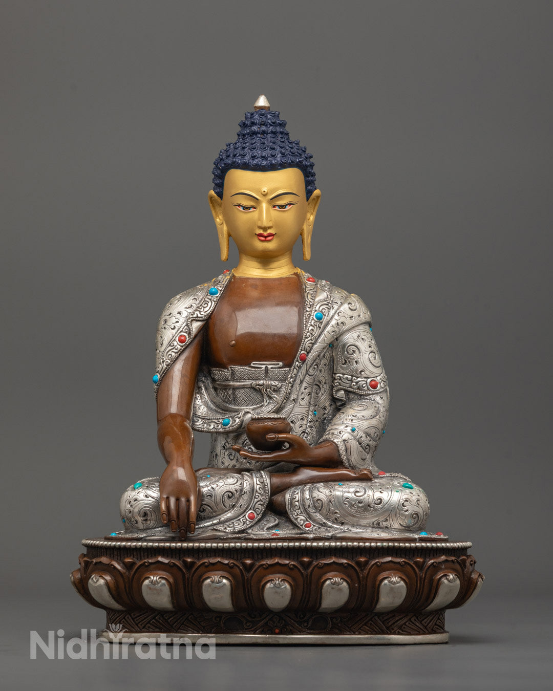 front view of Oxidized Shakyamuni Buddha Statue with 24K gold-gilded face and lotus base