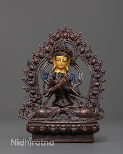 front view of Vajradhara statue with gold face and oxidized copper body on lotus base