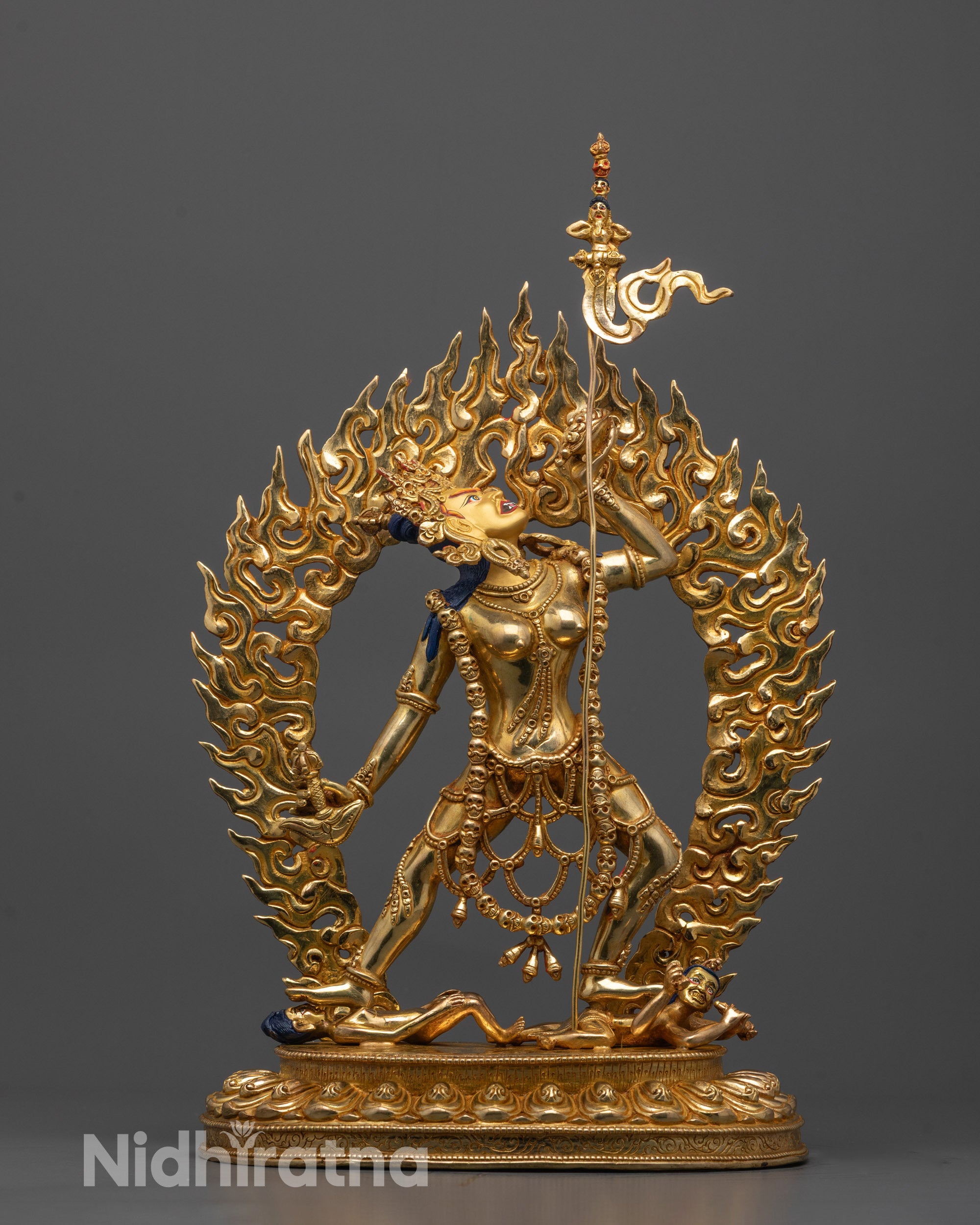front view of Vajrayogini statue with gold-gilded face and fire-gilded body on copper base