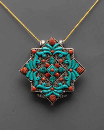 front view of authentic tibetan locket in silver with coral turquoise stones and filigree design
