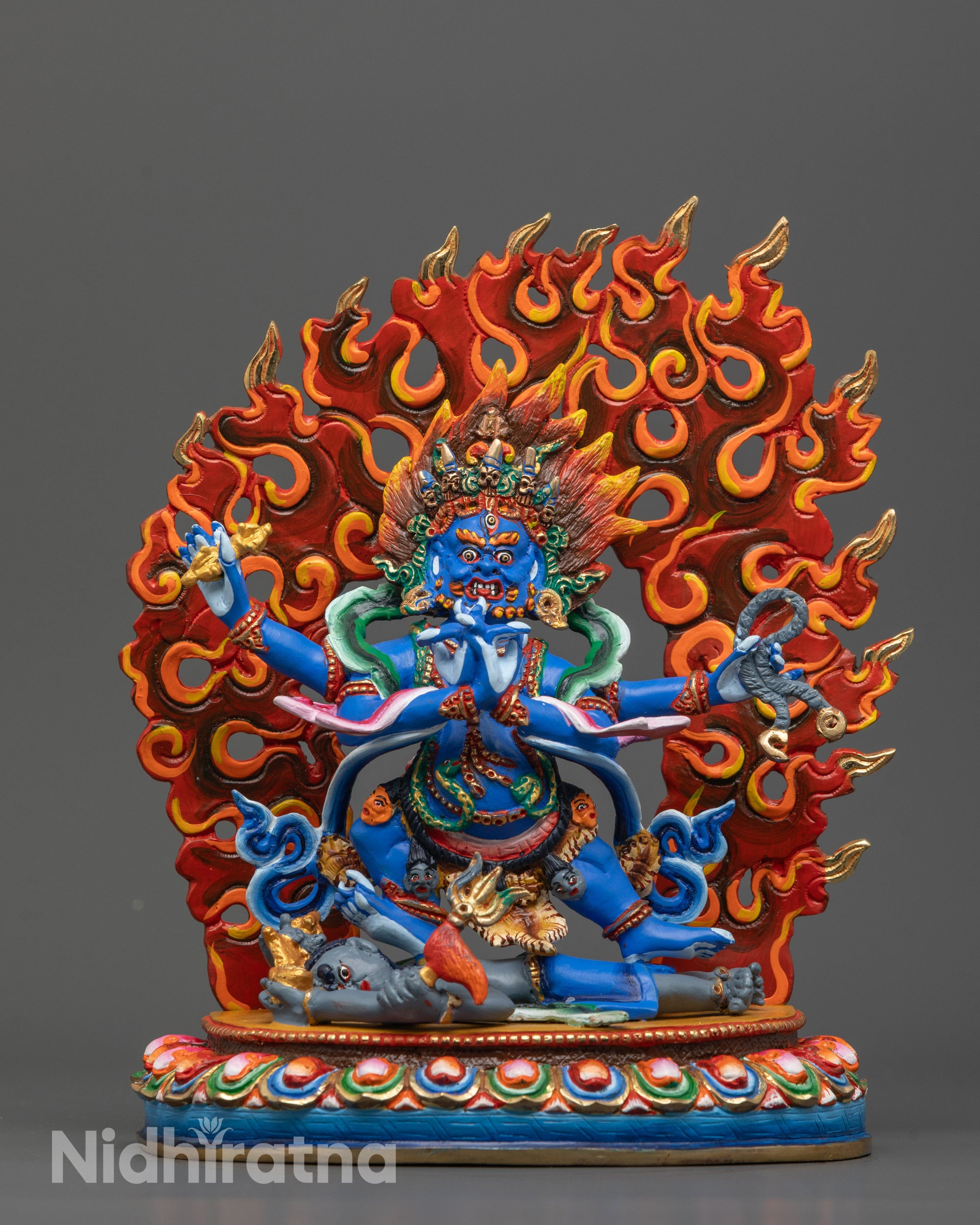 front view of colored four-armed vajrapani statue with blue body and blazing halo