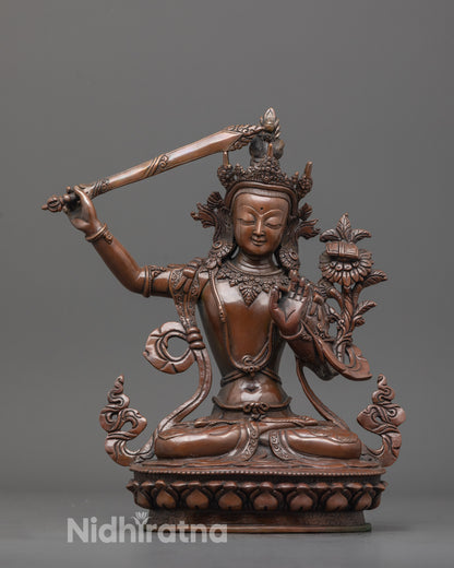 front view of elegant Manjushri statue with oxidized copper finish and lotus base
