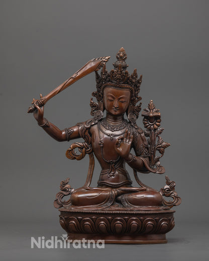 front view of hand-carved Manjushri statue with oxidized copper and lotus base finish