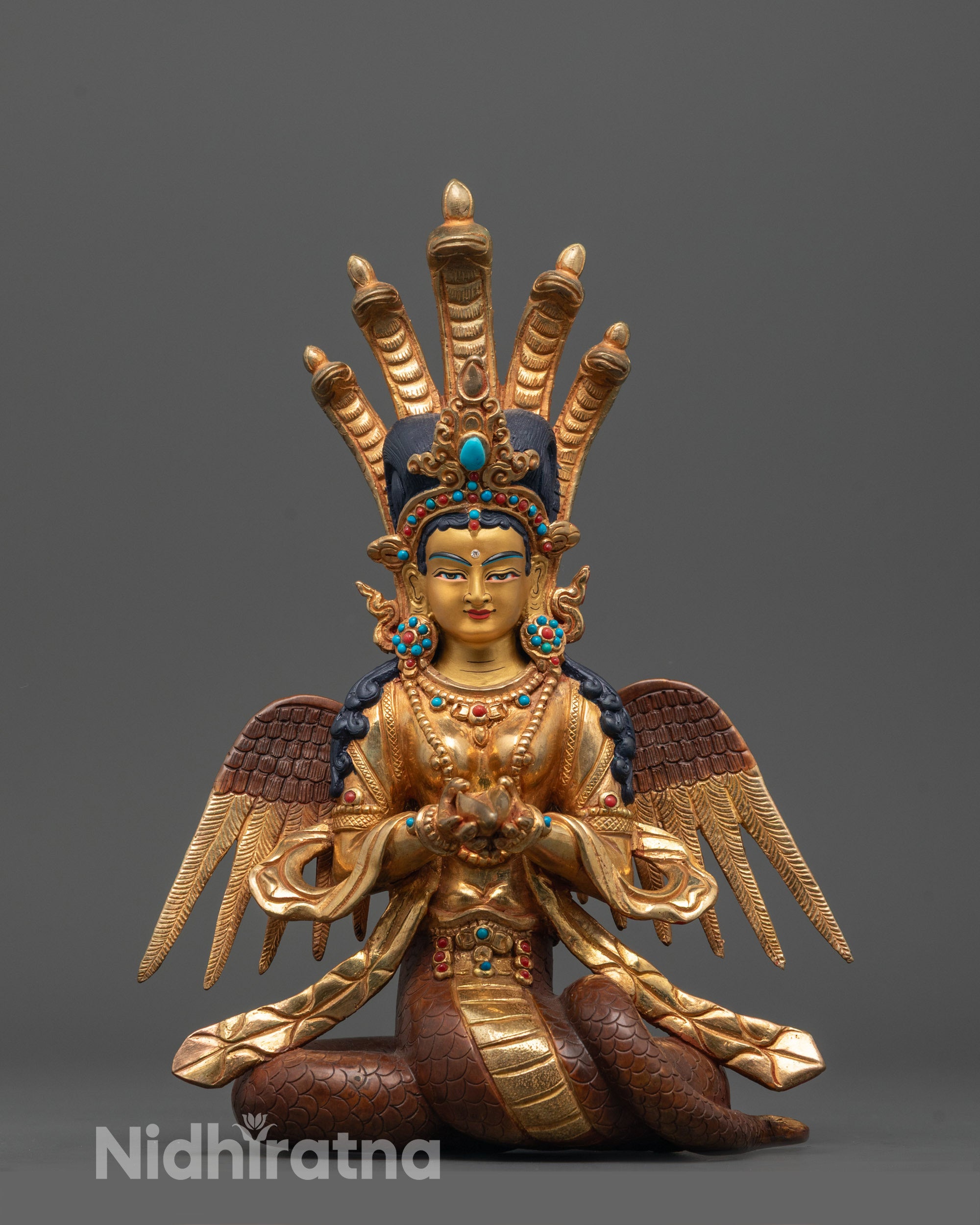 front view of handcrafted Naga Kanya statue with gold-gilded face and flowing robes