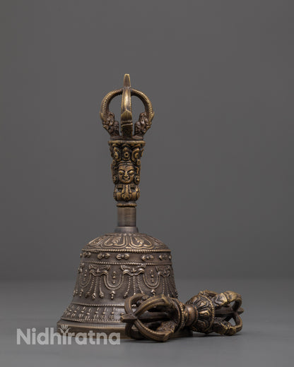front view of handcrafted bronze vajra and bell set with brass handle deity design