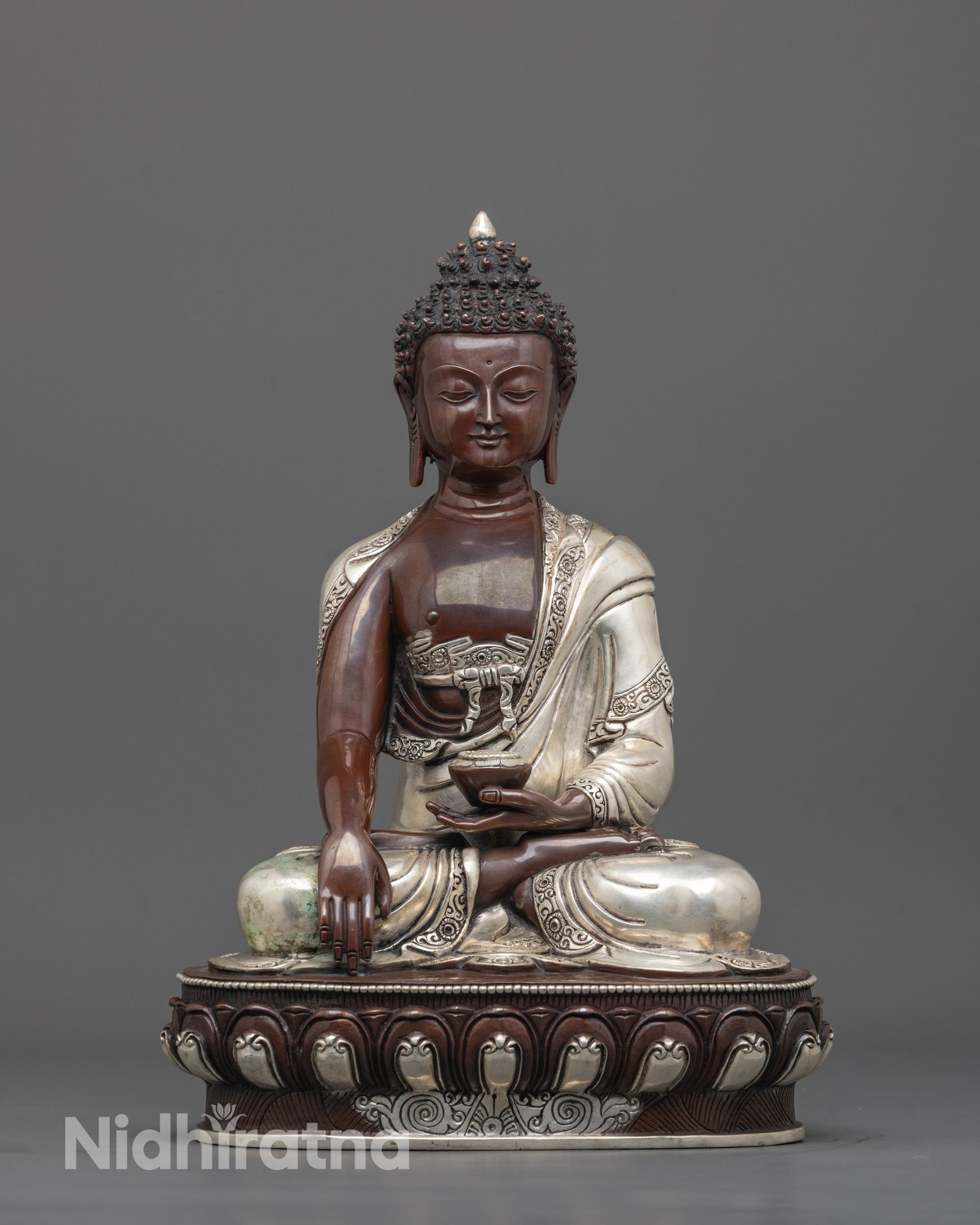 front view of handmade oxidized Buddha statue with silver-plated robe and patra bowl