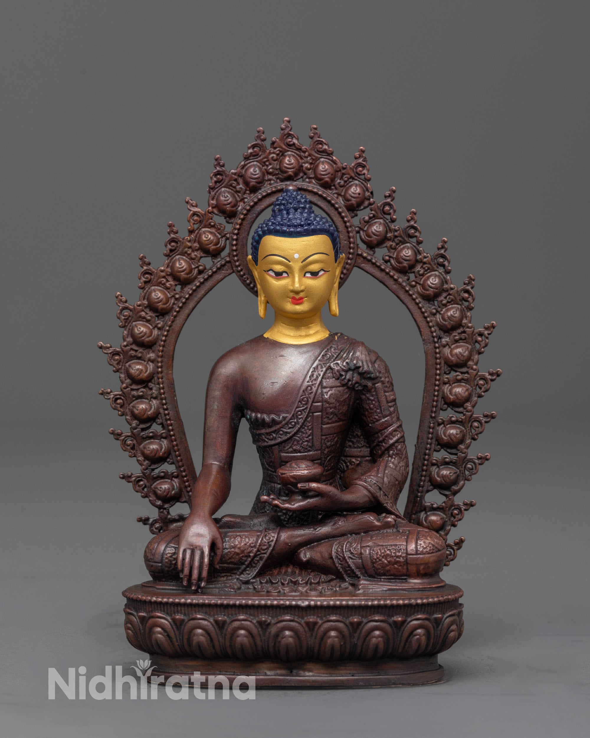 front view of machine-made Buddha Shakyamuni statue with gold-plated face and brown oxidized copper