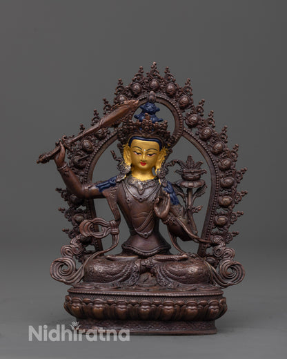 front view of manjushri statue with gold-plated face and oxidized copper body for wisdom decor