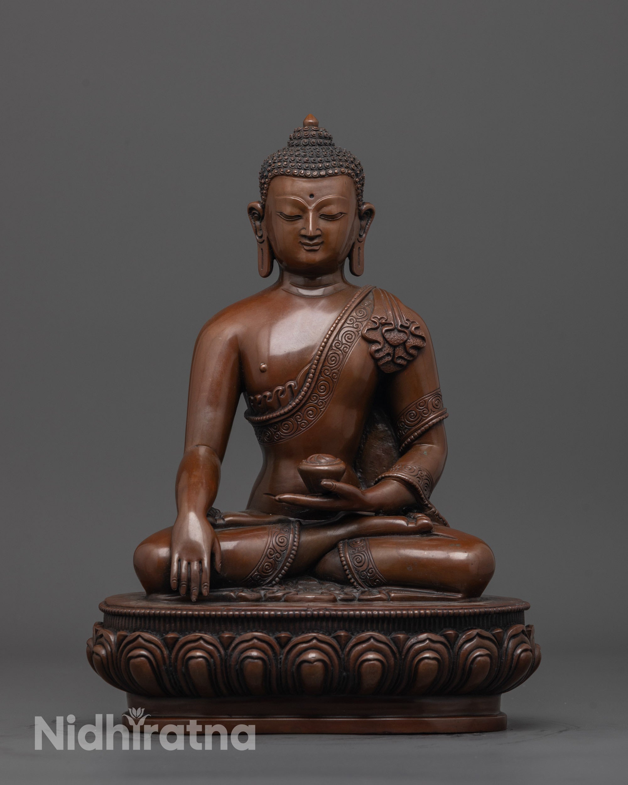 front view of oxidized Gautama Buddha statue with detailed robe and lotus seat