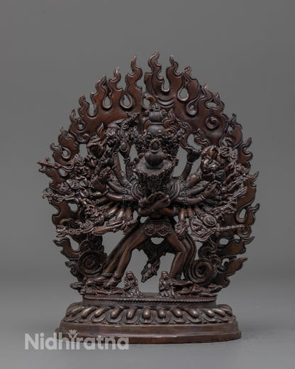front view of oxidized Kalachakra statue with fiery halo and multiple arms detailed close up