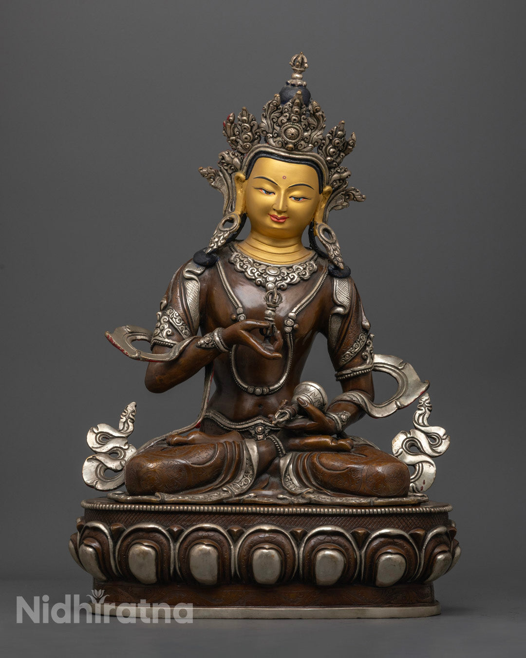 front view of oxidized copper vajrasattva statue with gold-gilded face and silver details
