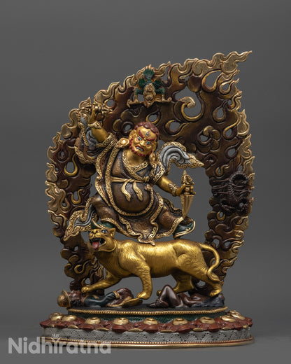 front view of oxidized dorje drolo statue with gold-plated details and halo
