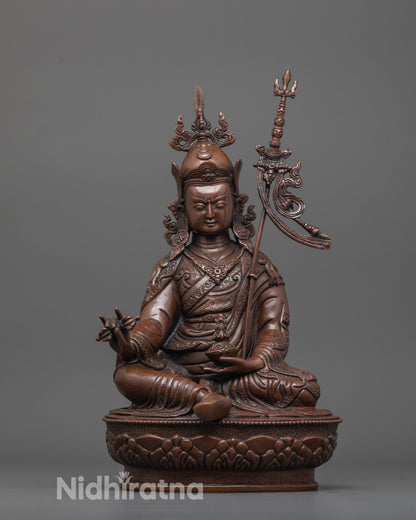 front view of oxidized guru rinpoche statue with lotus crown and tirpatika robe