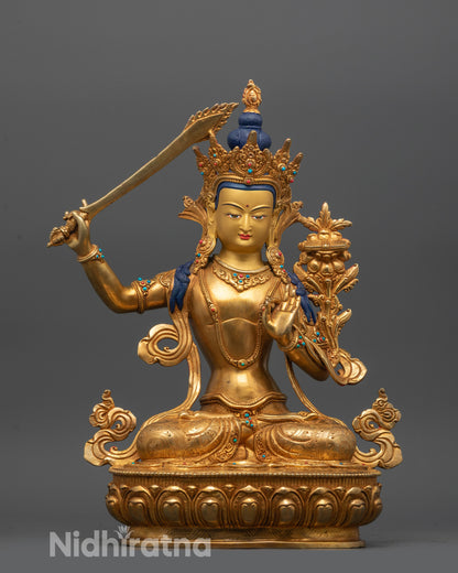 front view of traditional manjushri statue with gold-gilded face and fire-gilded copper body