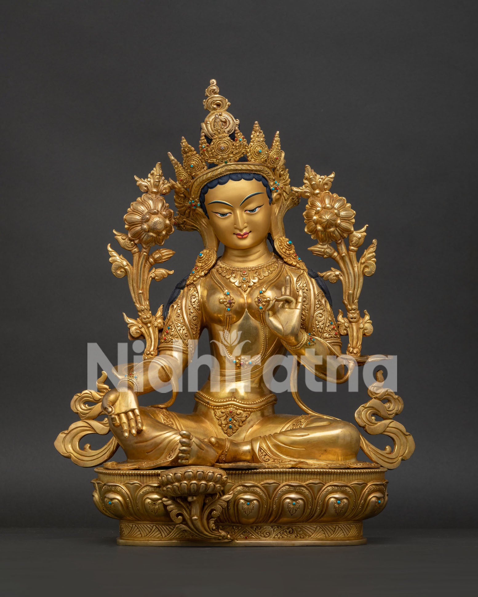 Full front view of gold-gilded Green Tara statue on lotus base, Newari Buddhist sculpture