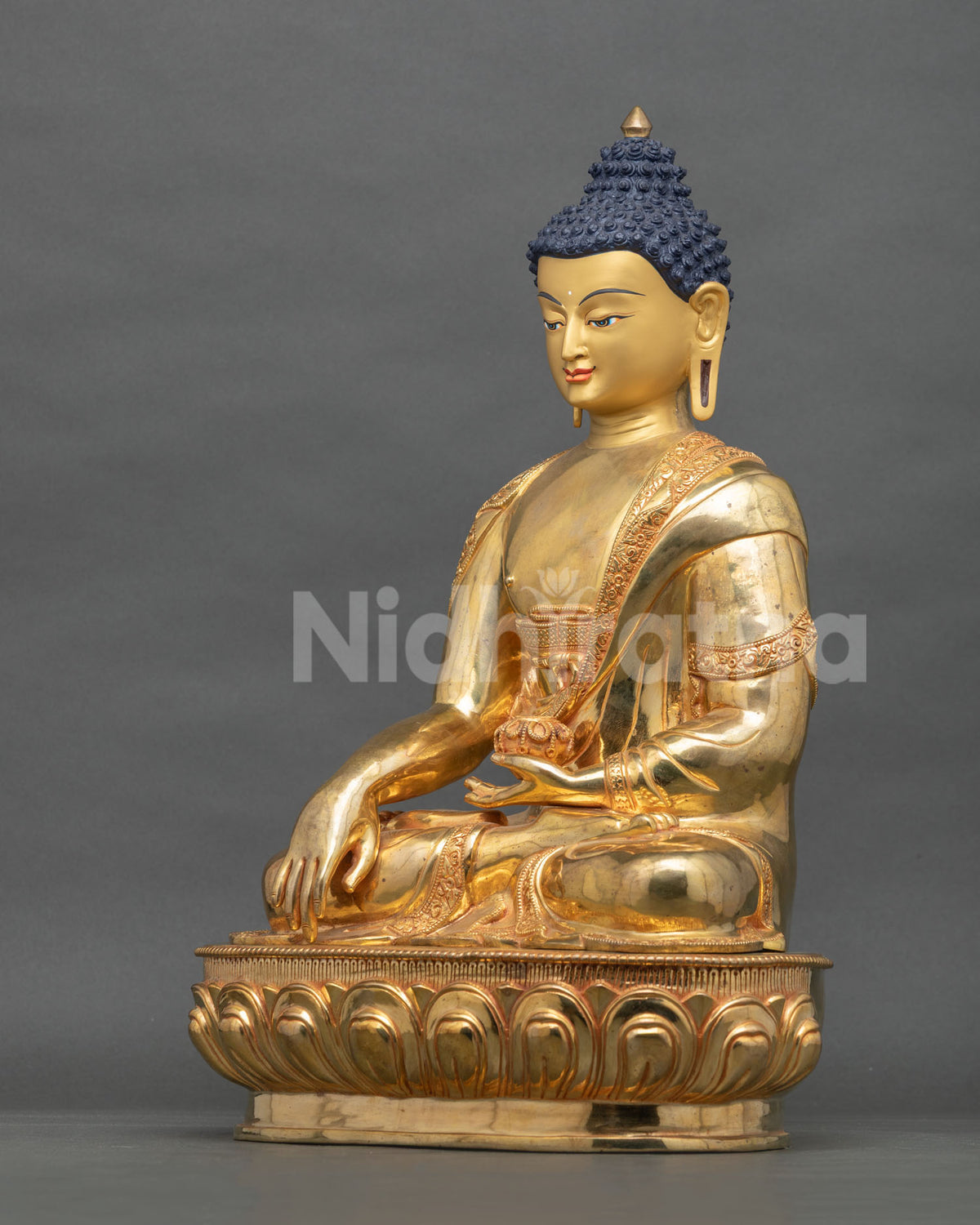 Full side view of Shakyamuni Buddha statue seated on a lotus base, handcrafted in Patan, Nepal