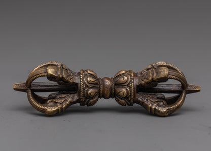 full view of handcrafted bronze vajra with detailed carvings for sacred tibetan rituals