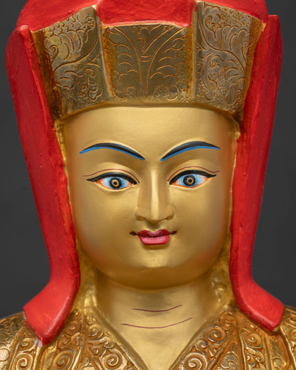 Gampopa statue detailed face close up showing serene expression and finely gold painted facial details