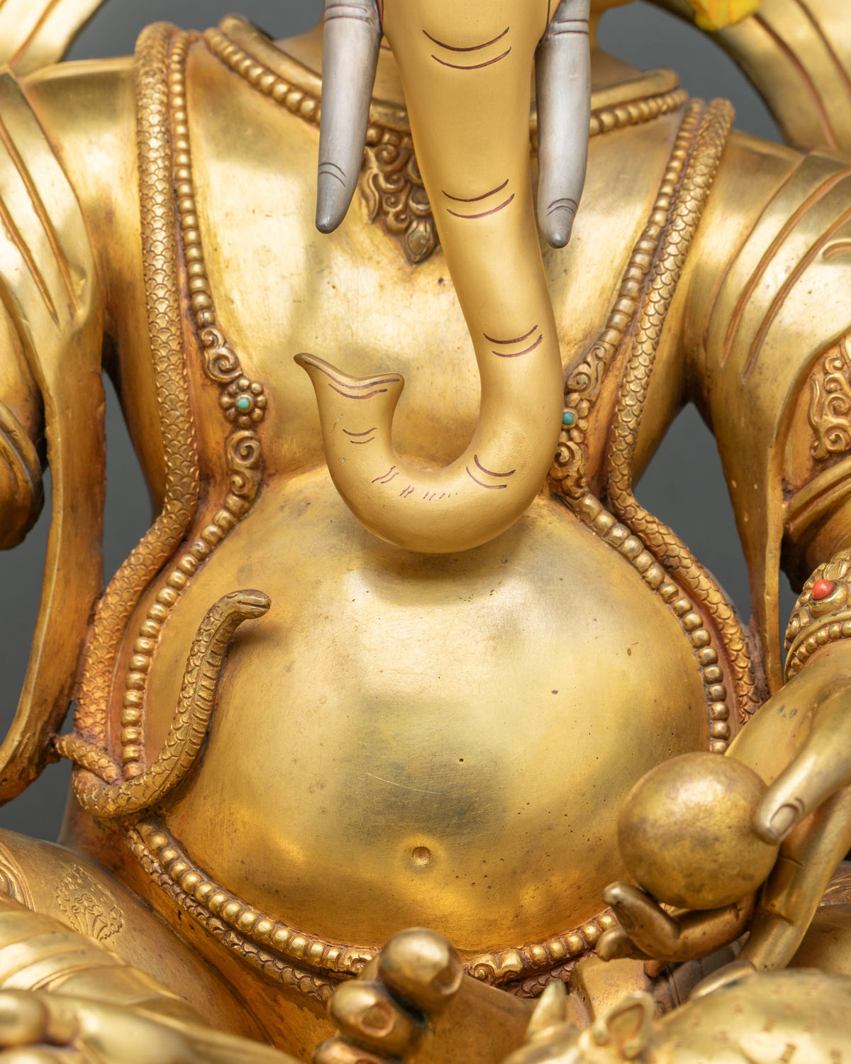 Ganesh belly with serpent sacred thread, curled trunk and finely engraved beaded jewelry detail
