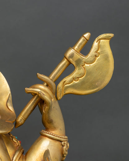Ganesh hand holding a gold axe that severs attachments, detail of a fire-gilded copper statue